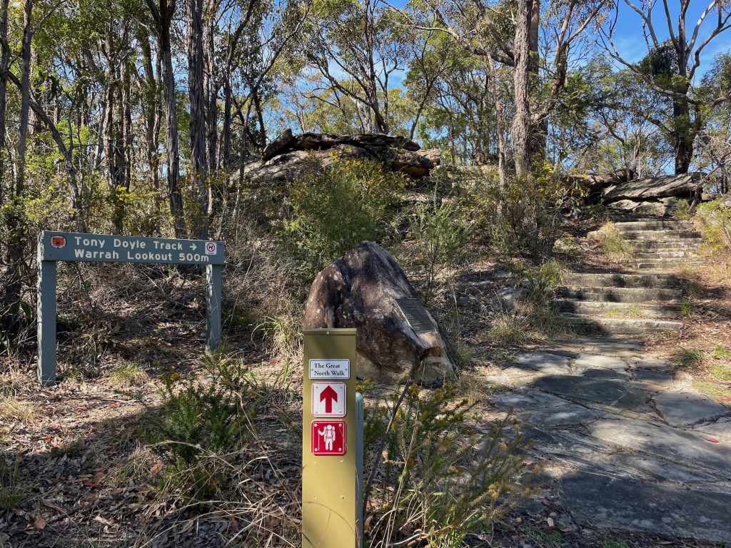 Signs for the Tony Doyle Track and Great North Walk near Warrah Trig